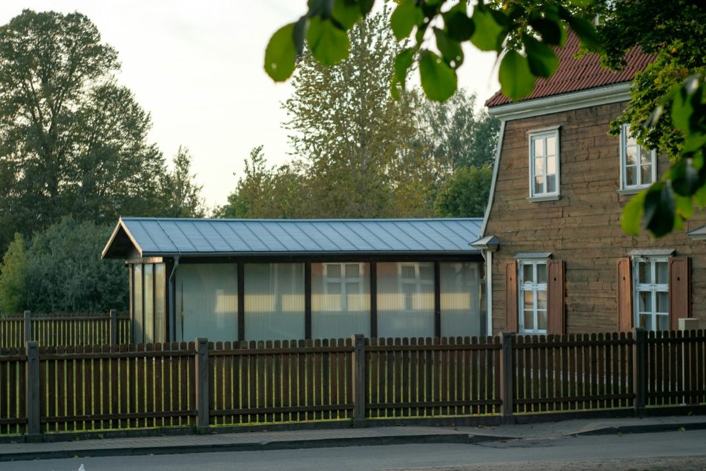A house with a metal roof and a fence around it